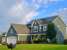 Rainbow over home with solar panels Waukesha Wisconsin